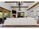 An open-concept living room features a stone fireplace, wood beam ceilings, and sliding glass doors to an outdoor patio at 8278 Raphael Ln, Littleton, CO 80125