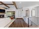 Elegant living room with wood beams, fireplace, and open floor plan at 8278 Raphael Ln, Littleton, CO 80125