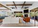 Open-concept living room with fireplace, hardwood floors, and beautiful backyard views at 8278 Raphael Ln, Littleton, CO 80125