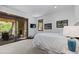 Main bedroom with outside patio access, stone fireplace, and mountain view at 8278 Raphael Ln, Littleton, CO 80125