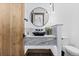This powder room includes a black vessel sink, marble counters, and sleek fixtures at 8278 Raphael Ln, Littleton, CO 80125