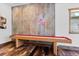 Recreation room with pool table, hardwood floors, rustic metal wall, and a novelty neon sign at 8278 Raphael Ln, Littleton, CO 80125