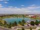 Scenic aerial view of a community lake, golf course, clubhouse, and neighborhood at 10109 Yampa St, Commerce City, CO 80022