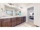Well-lit bathroom boasting double sinks, granite countertops, and modern fixtures at 10109 Yampa St, Commerce City, CO 80022
