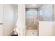 Tiled shower stall and toilet in bathroom with neutral color scheme at 10109 Yampa St, Commerce City, CO 80022
