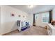 Comfortable carpeted bedroom with a crib, shuttered windows, and soft, natural light at 10109 Yampa St, Commerce City, CO 80022
