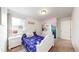 This bedroom features carpeted floors, a cozy bed, and abundant natural light at 10109 Yampa St, Commerce City, CO 80022