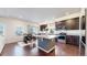 Bright kitchen with a center island, dark wood cabinets, and an eat-in dining area at 10109 Yampa St, Commerce City, CO 80022