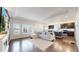 Open-concept living area with hardwood floors and bright windows, flowing into the kitchen at 10109 Yampa St, Commerce City, CO 80022