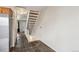 Hallway with slate tile flooring, white walls, and a carpeted staircase leading to the upper level at 17675 E Loyola Dr # E, Aurora, CO 80013