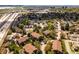 Aerial view of residential community with mature trees, pool, and highway access at 3001 S Ursula Cir # 101, Aurora, CO 80014