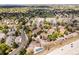 Aerial view of community with nearby highway, mature trees, pool, and tennis courts at 3001 S Ursula Cir # 101, Aurora, CO 80014