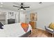 Bright bedroom with hardwood floors, a ceiling fan, and neutral paint with a comfortable chair at 3001 S Ursula Cir # 101, Aurora, CO 80014