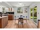 Modern kitchen and dining area with sleek black table set, stylish cabinets, and natural light from a large window at 3001 S Ursula Cir # 101, Aurora, CO 80014