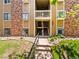 Inviting entrance to multi-Gathering unit featuring well maintained landscaping and an exterior stairwell at 3001 S Ursula Cir # 101, Aurora, CO 80014
