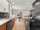 Stylish kitchen with black subway tile, wooden cabinets, modern appliances, and an adjacent dining area at 3001 S Ursula Cir # 101, Aurora, CO 80014