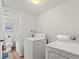 Convenient laundry room featuring washer and dryer with toilet and tub in the background at 3001 S Ursula Cir # 101, Aurora, CO 80014