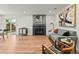 Spacious living room with hardwood floors, gray sofa, modern fireplace, and ample natural light at 3001 S Ursula Cir # 101, Aurora, CO 80014