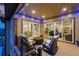 Cozy outdoor covered patio with comfortable seating and string lights, perfect for evening relaxation at 6469 Barnstead Dr, Castle Pines, CO 80108