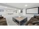 Large basement area with plenty of space for entertainment, featuring a comfortable seating area at 6469 Barnstead Dr, Castle Pines, CO 80108