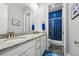 Bathroom featuring double vanity with granite countertops and a stylish tiled shower at 6469 Barnstead Dr, Castle Pines, CO 80108