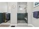 Modern bathroom featuring a glass-enclosed shower with dual shower heads and a stylish clock on the wall at 6469 Barnstead Dr, Castle Pines, CO 80108
