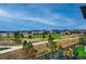 Scenic view of the community with a large green space, walking path, and well-maintained homes at 6469 Barnstead Dr, Castle Pines, CO 80108