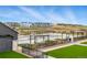 Community Pool and outdoor seating area surrounded by lush landscaping in a park-like setting at 6469 Barnstead Dr, Castle Pines, CO 80108