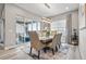 Bright dining area featuring sliding glass doors, modern chandelier, and seating for six at 6469 Barnstead Dr, Castle Pines, CO 80108