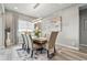 Elegant dining room with modern chandelier, large table, and stylish decor at 6469 Barnstead Dr, Castle Pines, CO 80108