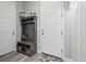Inviting entryway with a rustic bench and storage, complemented by a white door and stylish decor at 6469 Barnstead Dr, Castle Pines, CO 80108