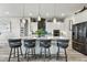 Modern kitchen with large island with seating, a stylish backsplash, and stainless steel appliances at 6469 Barnstead Dr, Castle Pines, CO 80108