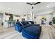 Open-concept living area with hardwood floors, a blue sofa, and modern kitchen at 6469 Barnstead Dr, Castle Pines, CO 80108
