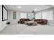 Spacious living room featuring comfortable sofas, a large screen, and ample natural light at 6469 Barnstead Dr, Castle Pines, CO 80108