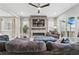 Bright living room with modern fireplace, large TV, and comfortable seating area at 6469 Barnstead Dr, Castle Pines, CO 80108