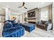 Stylish living room featuring fireplace, large TV, and a neutral color palette at 6469 Barnstead Dr, Castle Pines, CO 80108