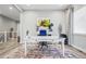 Well-lit home office with a white desk, comfortable seating, and bright decor at 6469 Barnstead Dr, Castle Pines, CO 80108