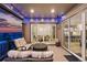 Inviting covered patio with comfortable seating and views of the sunset, open to the dining and kitchen areas at 6469 Barnstead Dr, Castle Pines, CO 80108