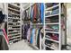 Well-organized walk-in closet with ample storage space for shoes, clothes, and accessories at 6469 Barnstead Dr, Castle Pines, CO 80108