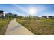 Paved community walking path through green spaces, surrounded by modern homes at 6469 Barnstead Dr, Castle Pines, CO 80108
