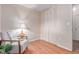 Bedroom with hardwood floors, large closets and accent chair at 1285 Elder St, Denver, CO 80221