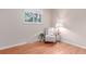 Bedroom with hardwood floors, a window, and accent chair at 1285 Elder St, Denver, CO 80221