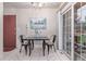 Cozy dining area with a simple table setting, sliding glass door, and decorative wall art at 1285 Elder St, Denver, CO 80221