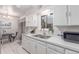 Bright kitchen with stainless steel sink, white cabinets, and a view from the window at 1285 Elder St, Denver, CO 80221