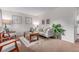 Bright living room with neutral tones, comfortable sofa, stylish accents, and a view into the next room at 1285 Elder St, Denver, CO 80221