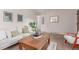The comfortable living room features neutral carpet, stylish wooden coffee table, and decor at 1285 Elder St, Denver, CO 80221