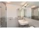 Bright bathroom featuring a mirrored vanity and tiled shower with glass door at 3100 E Cherry Creek South Dr # 404, Denver, CO 80209