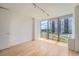Well-lit bedroom with light colored wood floors and large windows providing natural light and views at 3100 E Cherry Creek South Dr # 404, Denver, CO 80209