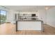 Sleek kitchen with stainless steel appliances, island and hardwood floors at 3100 E Cherry Creek South Dr # 404, Denver, CO 80209