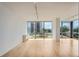 Open living room with large windows and hardwood floors overlooking city view at 3100 E Cherry Creek South Dr # 404, Denver, CO 80209